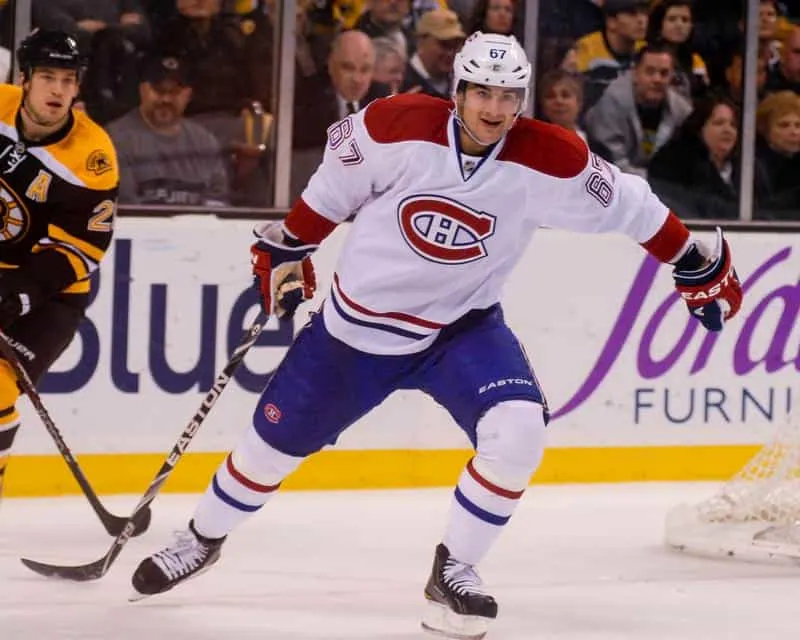 The Montreal Canadiens, led by their Captains, are playing against the Boston Bruins.